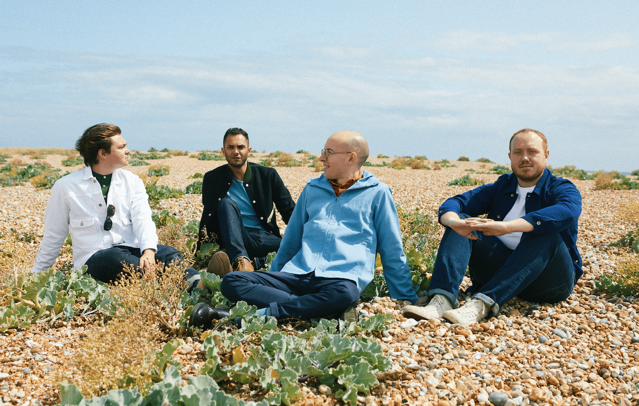 Bombay Bicycle Club sat on a pebble beach